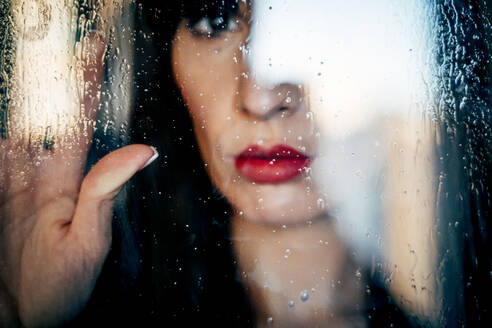 Attraktive Frau mit roten Lippen küsst leidenschaftlich sauberes transparentes Glas - ADSF10370
