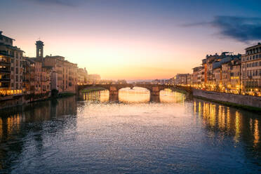 City bridge with buildings above river in sunset light, Florence, Italy - ADSF10503