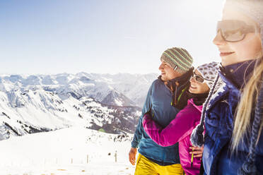 Eine Gruppe von Freunden genießt die Aussicht von einem Berggipfel im Winter, Achenkirch, Österreich - DHEF00251