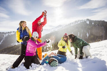 Group of carefree friends having fun in snow, Achenkirch, Austria - DHEF00291