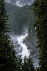 Clean water falling from rough cliff of foggy day in peaceful countryside in Austria - ADSF10790