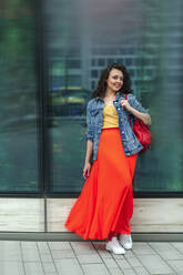 Young smiling woman leaning on wall - OGF00462