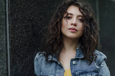 Portrait of smiling young woman standing against a mirror wall - OGF00474