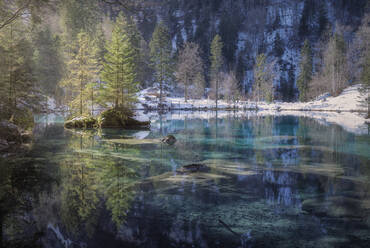 Landscape of peaceful azure lake with snowy shore in mountains of Switzerland - ADSF10807