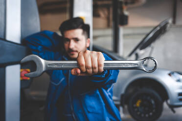 Auto mechanic with wrench, selective focus. - CAVF88115