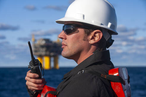 Offshore energy production with person on ship - CAVF88153