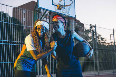 Hand spinning the basketball on a finger with blue sky background stock  photo