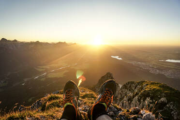 HIking shoes of hiker on viewpoint during sunset, Saeuling, Bavaria, Germany - MALF00056