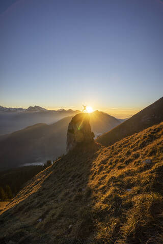 Hiker on viewpoint during sunset, Aggenstein, Bavaria, Germany stock photo
