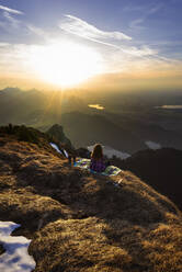 Female hiker during sunset, Saeuling, Bavaria, Germany - MALF00066