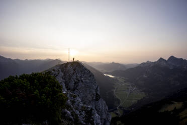 Hiker on viewpoint during sunset, Gaichtspitze, Tyrol, Austria - MALF00073