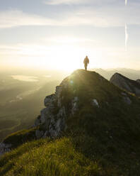 Hiker on viewpoint during sunrise, Brentenjoch, Bavaria, Germany - MALF00090