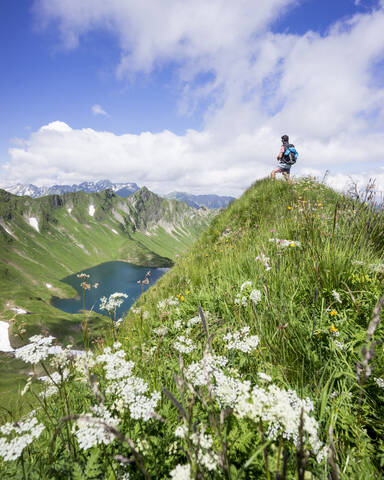 Hiker on viewpoint, Lake Schrecksee, Bavaria, Germany stock photo