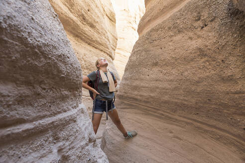 12 year old girl hiking in beautiful slot canyon Kasha Katuwe Tent Rocks NM. - MINF15050