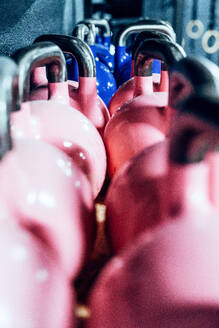 Set of pink kettlebells on shelves in modern health club - ADSF11171