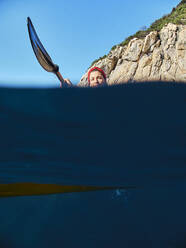 Woman with oar against clear blue sky - VEGF02701