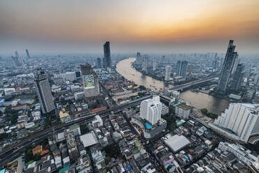 Thailand, Bangkok, Aerial view of capital city downtown at sunset - RUNF04067