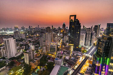 Thailand, Bangkok, Aerial view of capital city downtown at dusk - RUNF04070