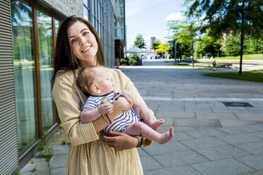 Mother with her baby boy in the city - IHF00400