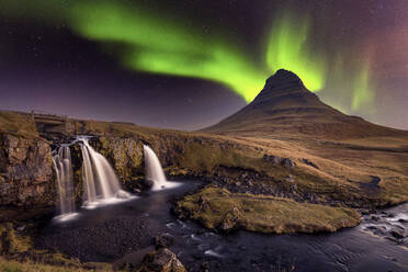 Aurora Borealis (Northern Lights) over Kirkjufell Mountian with a small waterfall in Iceland, Polar Regions - RHPLF17448