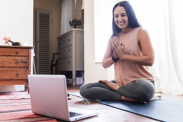 Smiling mature woman using laptop at home - FMOF01047