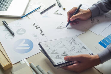 Graphic designer drawing sketch design creative Ideas draft Logo - CAVF88419