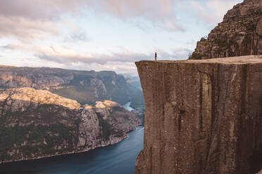 Mann steht am Rande einer Klippe am Preikestolen, Norwegen - CAVF88468