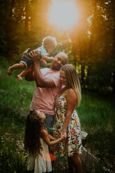 Vertical portrait of biracial family looking at each other - CAVF88533