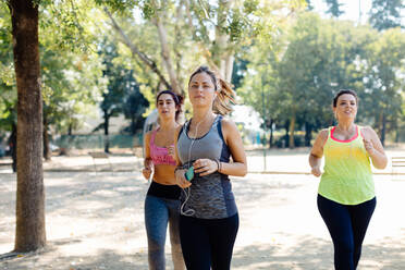 Three friends jogging in park - CUF56203