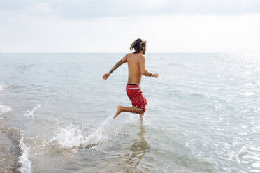 Man running into sea - CUF56233