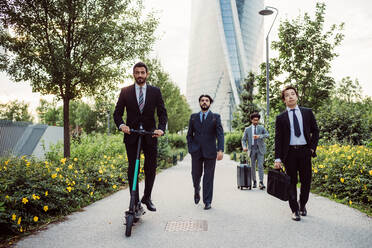 Mixed race group of businessmen hanging out together in town. - CUF56445