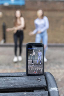 Young female friends self taping dance video for social media - WPEF03295