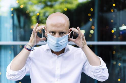 Bald man wearing protective mask responsibly - DGOF01240