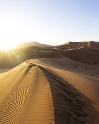 Sun setting over vast barren desert - MALF00131