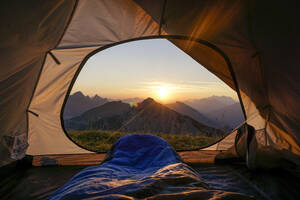 Tent pitched in Allgau Alps at sunset with Sulzspitze in background - MALF00138
