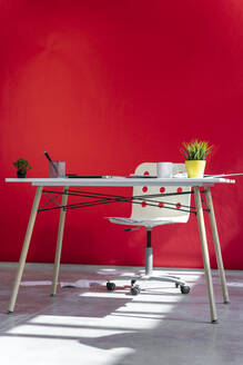Office desk and red wall in the background - AFVF06977