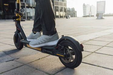 Low section of businessman riding electric push scooter at downtown - VPIF02962