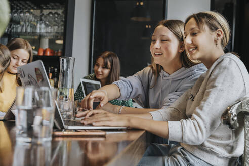 Mädchen im Teenageralter studieren und lernen von zu Hause aus mit Laptops - MFF06008