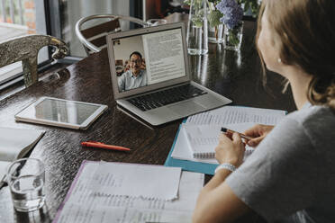 Teenage girl studying from home, using laptop - MFF06019