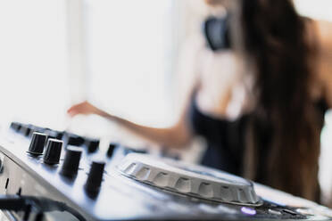 Close-up of sound equipment against music producer at recording studio - MRRF00283