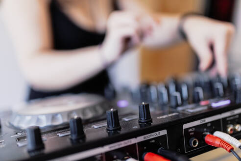 Mittelteil eines weiblichen DJs, der in einem Aufnahmestudio den Ton mischt - MRRF00288