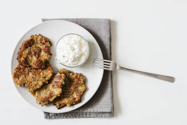 Studio shot of rye and turnip pancakes with sour cream-yogurt dipping sauce - EVGF03666