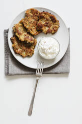 Studio shot of rye and turnip pancakes with sour cream-yogurt dipping sauce - EVGF03676