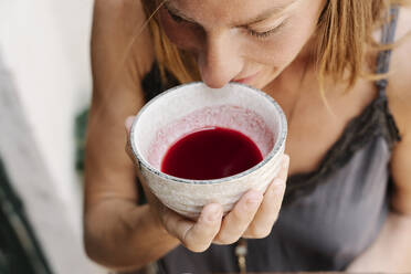 Close-up of woman drinking fresh matcha tea - RDGF00099