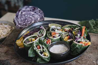 Vegan rolls with vegetables and yoghurt sauce in bowl - ALBF01375