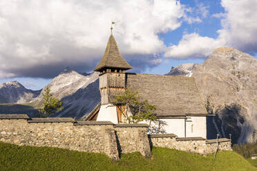 Switzerland, Canton of Grisons, Arosa, Stone wall in front of Bergkirchli in summer - WDF06171