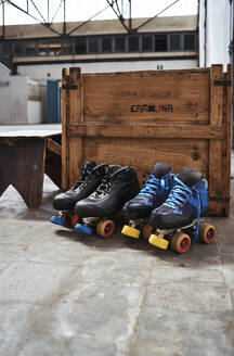 Roller skates against wooden box on sports court - VEGF02808