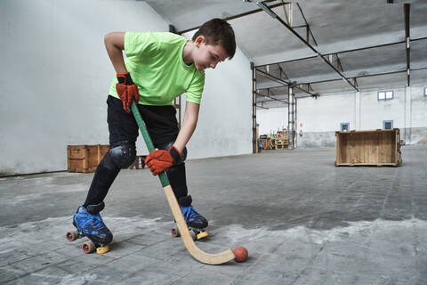 Boy practicing roller hockey during training at court stock photo