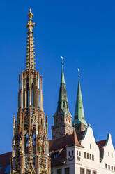 Deutschland, Bayern, Nürnberg, Schoner Brunnen mit Türmen der St. Sebaldus Kirche im Hintergrund - WDF06228