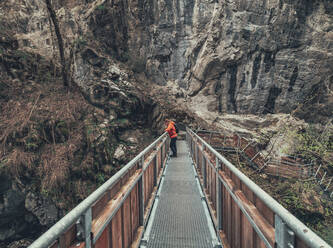 Seitenansicht eines Wanderers auf einem von Bäumen umgebenen Wanderweg in den Dolomiten, Italien - ADSF12145